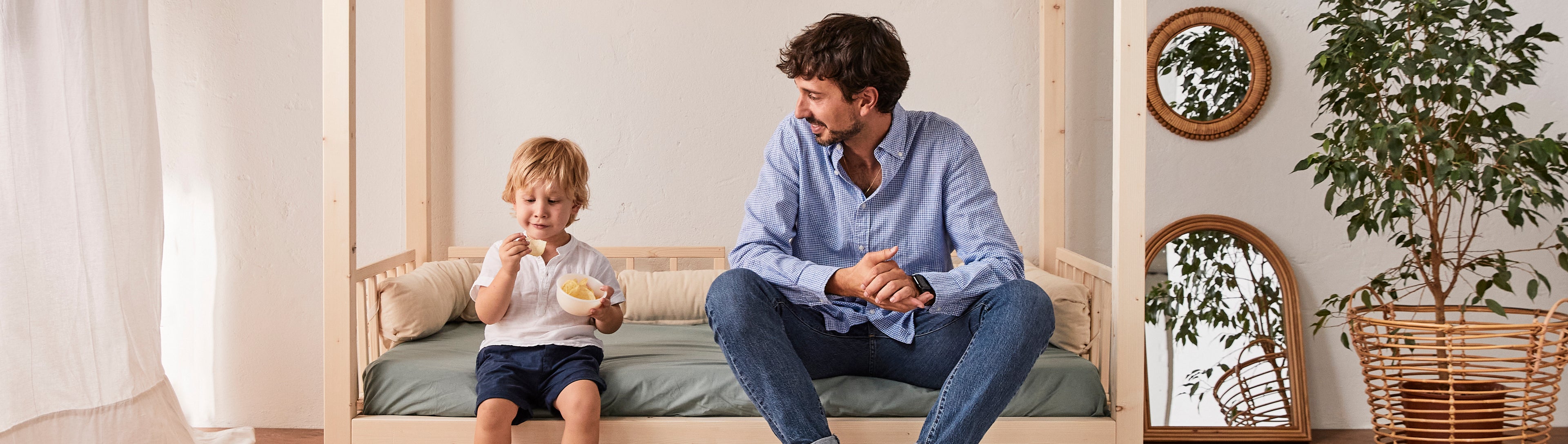 bimbo e papà su lettino montessoriano in legno naturale dream con baldacchino nabè
